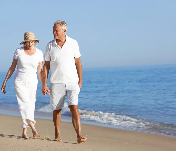 Couple sitting together and filing Spanish non-resident Modelo 210 tax on a laptop